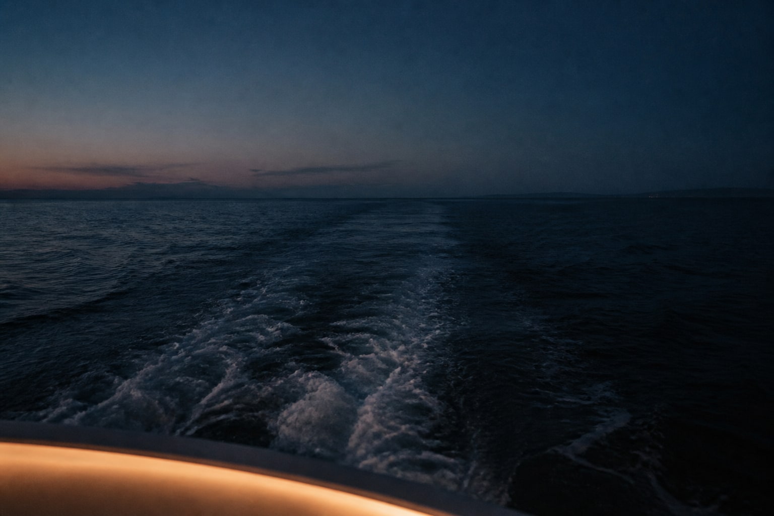 A fictional dayboat wake fading into blue hour